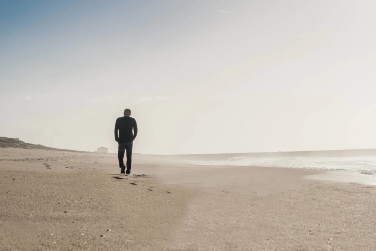silhouette of man mindful walking on beach